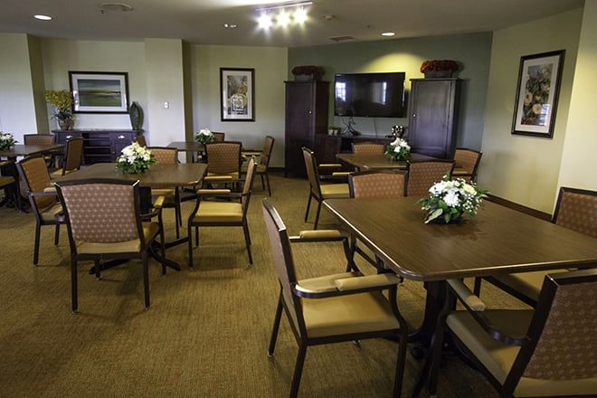 Interior view of Brookdale Dowlen Oaks senior living community featuring dining area, art, and electronics.