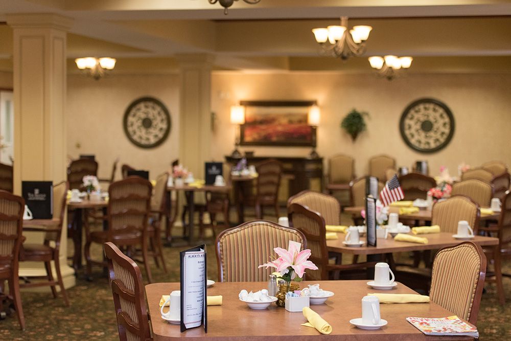 Interior view of Garden Plaza Of Florissant senior living community featuring dining area and café.