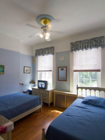Senior living community Riverview Lodge bedroom with furniture, electronics, and art.