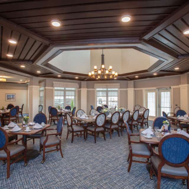 Interior view of Cornerstone At Hampton senior living community featuring dining area and lounge.