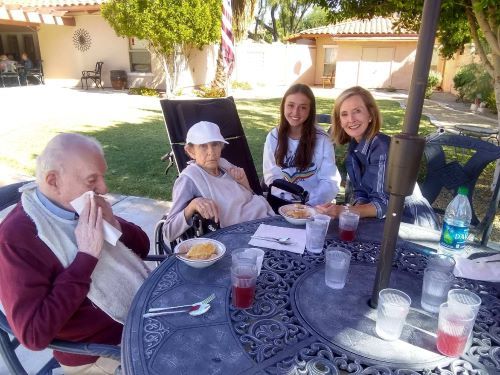 Senior women enjoying a meal at the dining table in Barton House's outdoor villa.