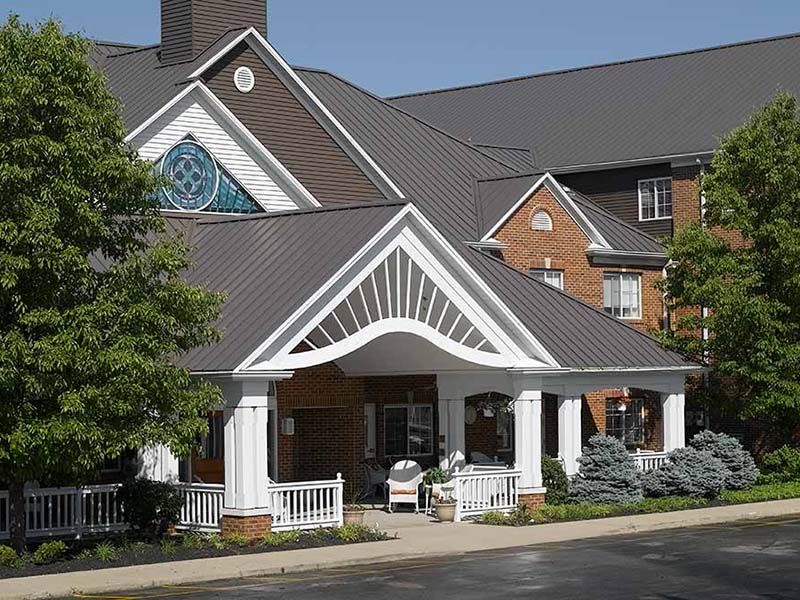 Senior living community, Celebration Villa of Summit Hills, showcasing its architectural building, housing, and portico.
