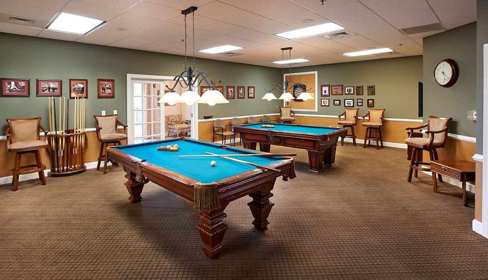 Senior living community Redstone Village with furnished billiard room featuring pool table.