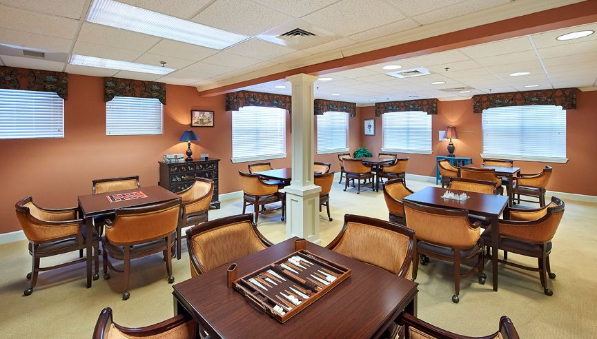 Interior view of Redstone Village's senior living dining area with wooden furniture and design.