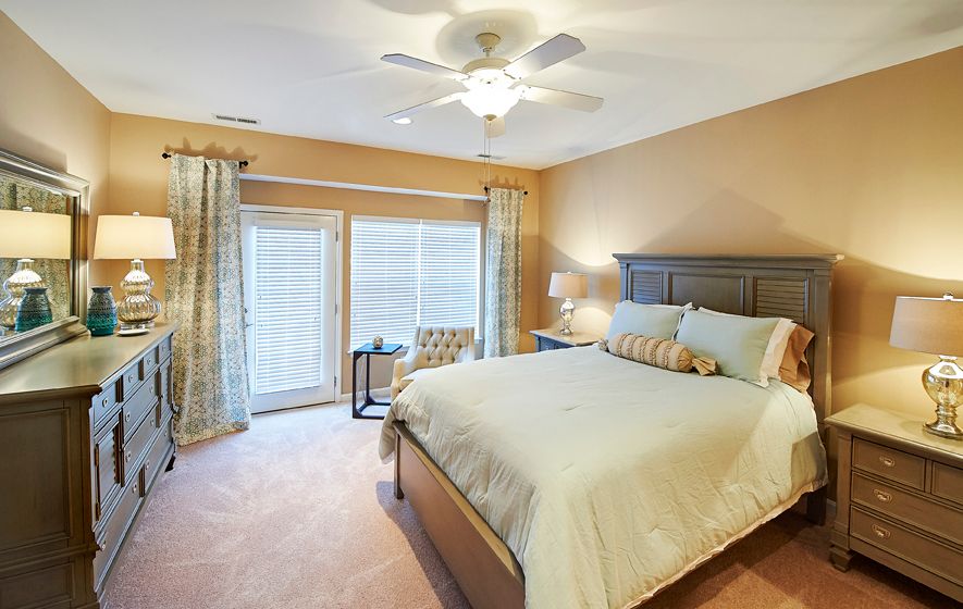 Interior of a bedroom at Redstone Village senior living community, featuring modern decor and appliances.