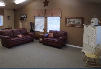 Interior view of The Cottages of Meridian senior living community featuring cozy living room decor.