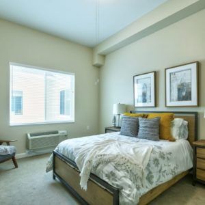 Interior view of a furnished bedroom at Discovery Village At Westchase senior living community.