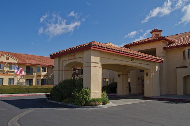 Senior living community, Whispering Winds of Apple Valley, featuring villa-style housing and tile roofs.