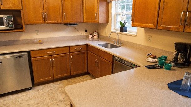 Senior living kitchen at Arden Courts Of West Orange featuring wood cabinets and modern appliances.