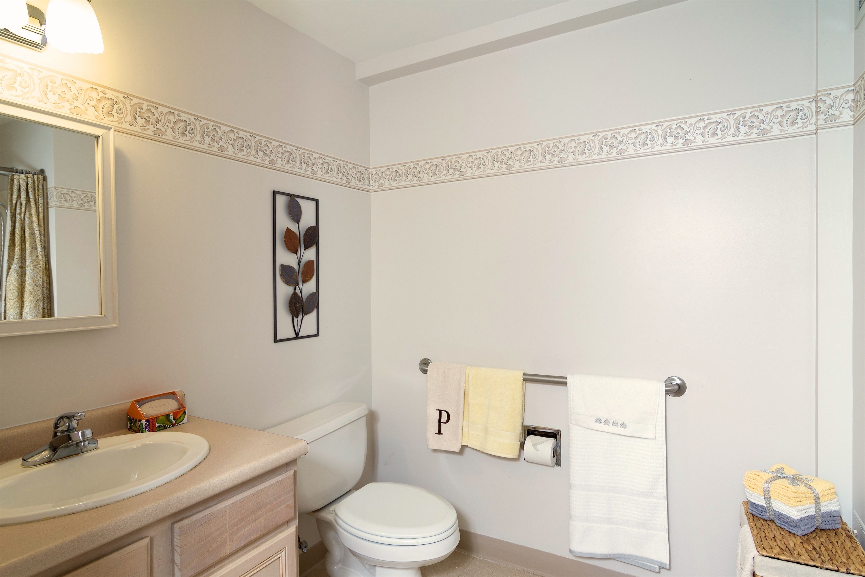 Interior view of Pacifica Senior Living Victoria Court featuring a bathroom with art and accessories.