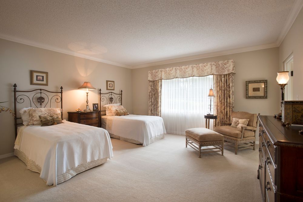 Corner view of a furnished bedroom in Regency Oaks senior living community with elegant home decor.