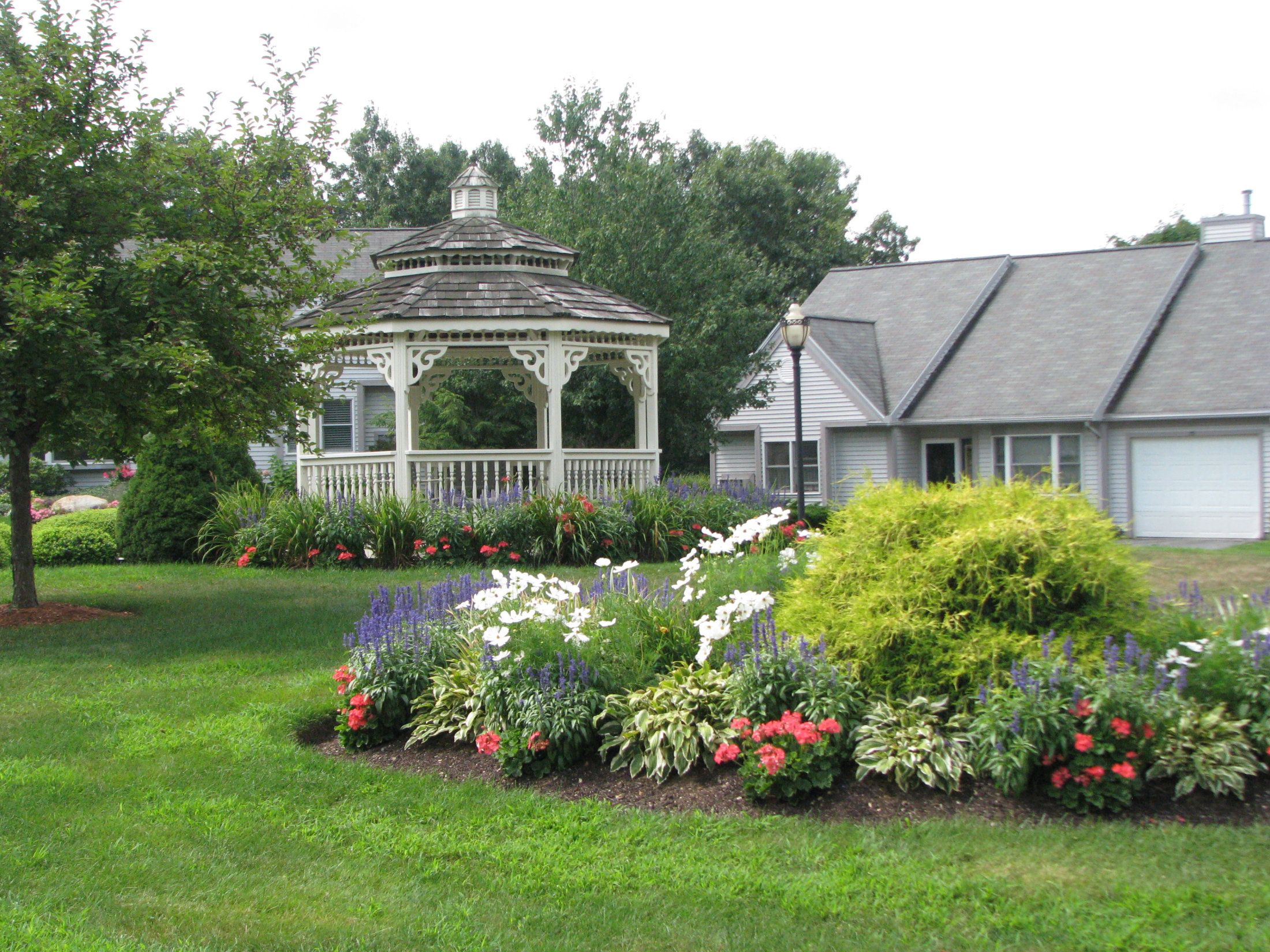 Senior living community Briarwood with lush gardens, gazebo, and beautiful architecture.
