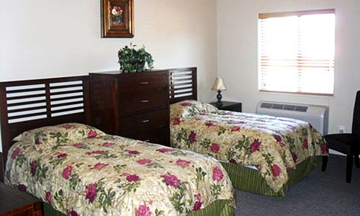 Bedroom interior at Serenity Place Residential Care, featuring comfortable furniture and home decor.