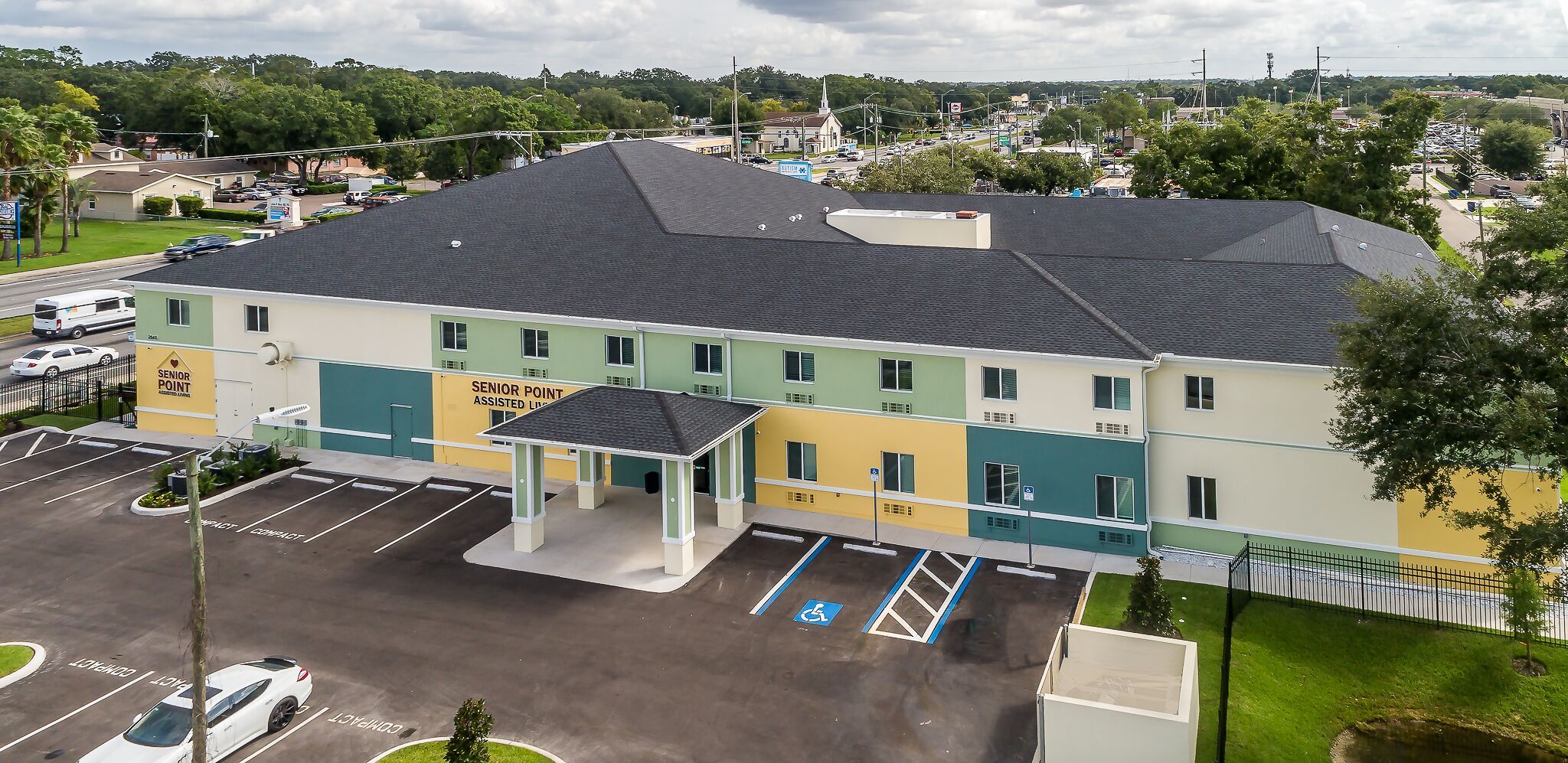 Aerial view of Senior Point Assisted Living Facility with outdoor housing, vehicles, and architecture.