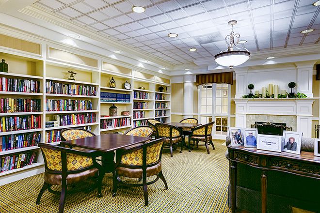 Interior view of Brookdale Northbrook senior living community featuring a library and dining area.