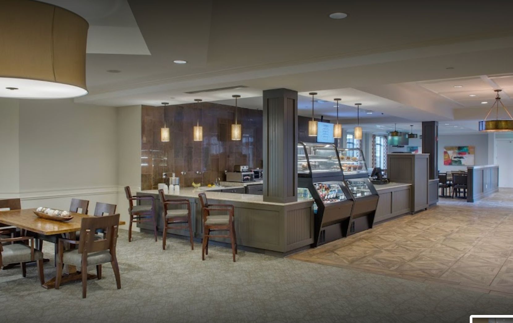 Interior view of Somerby Franklin senior living community's cafeteria with modern architecture and design.