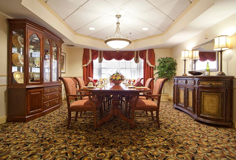 Interior view of Coral Oaks senior living community featuring elegant dining room decor and architecture.