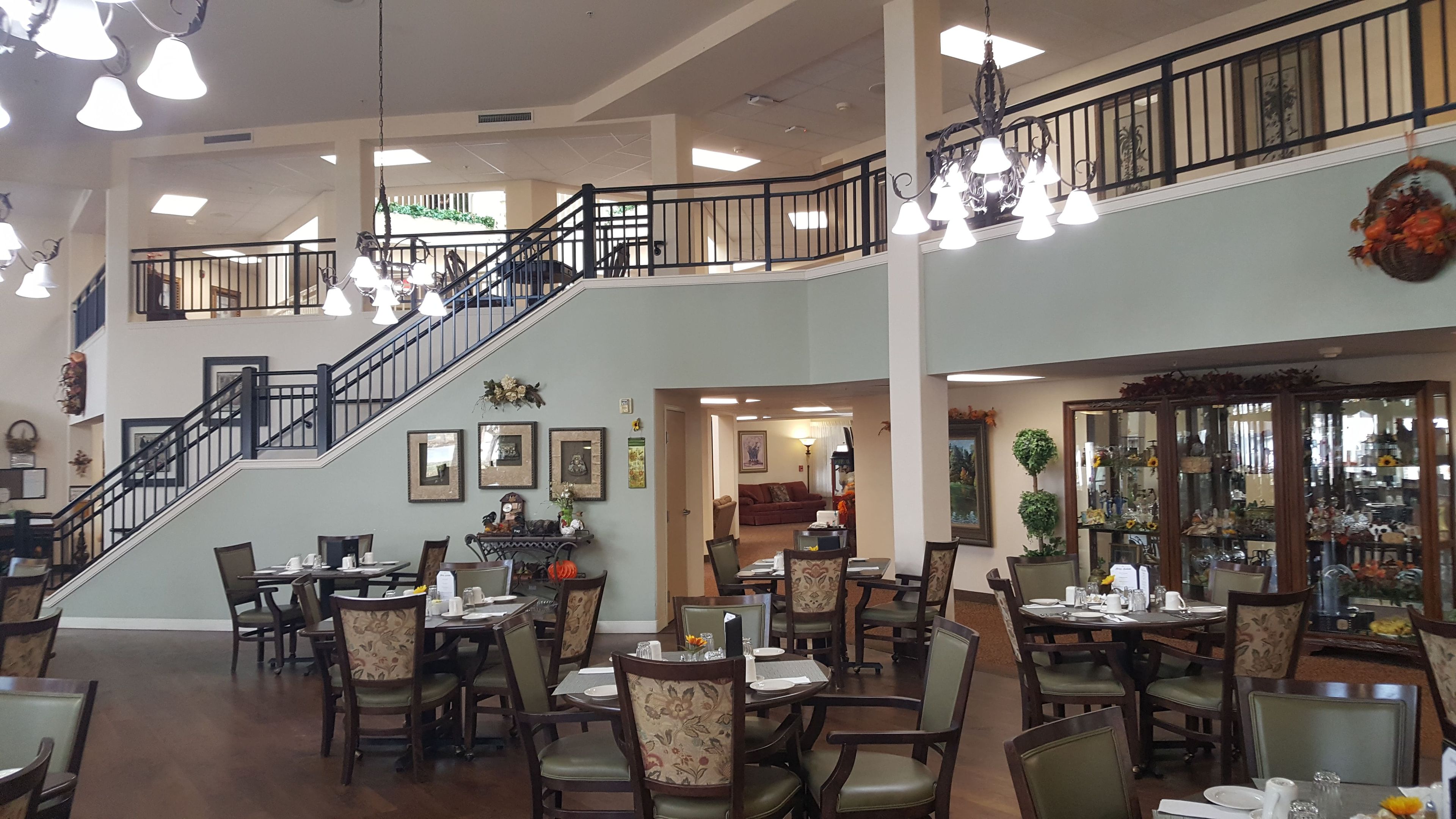 Interior view of Solstice Senior Living At Lees Summit featuring dining area, art, and decor.