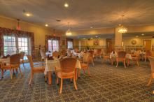 Senior residents enjoying in the spacious dining and reception area of Morningside of Springfield.