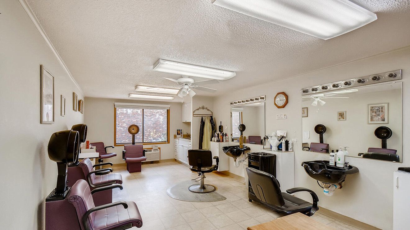 Senior living community Woodlands Village featuring a beauty salon, barbershop, and modern appliances.