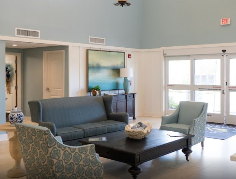 Interior view of Seagrass Village senior living room with modern furniture, decor, and a bird.