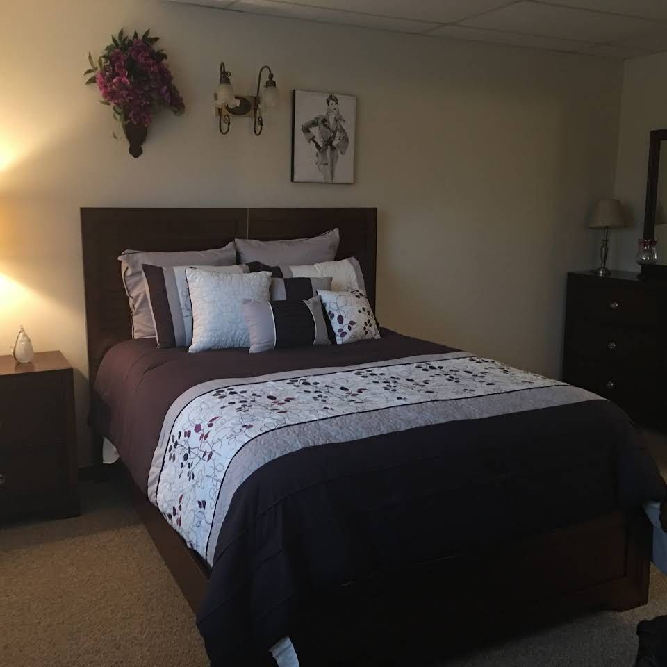 Bedroom interior with furniture and decor at Gordon Oaks Senior Living Community.