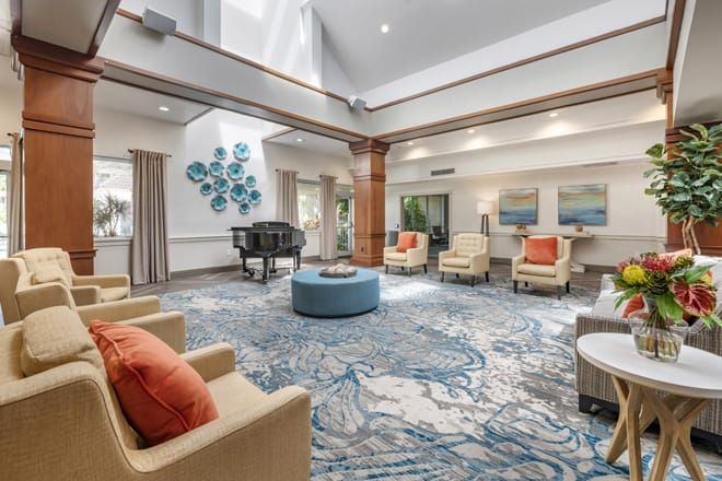 Senior living community Brookdale West Palm Beach featuring a piano, art, and cozy decor in the reception room.