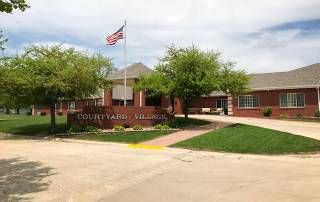 Senior living community, Courtyard Village of Kewanee, featuring urban architecture amidst nature.