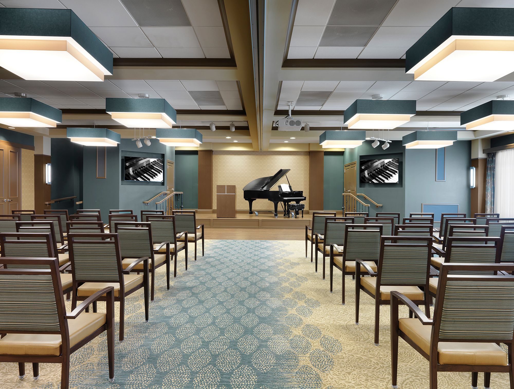 Senior living community Kingswood's foyer with piano, chairs, and classroom architecture.