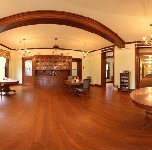 Interior view of Hume Home of Muskegon senior living community featuring hardwood floors and elegant furniture.
