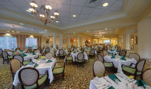 Senior living community Aston Gardens At Tampa Bay featuring a dining room with elegant furniture.