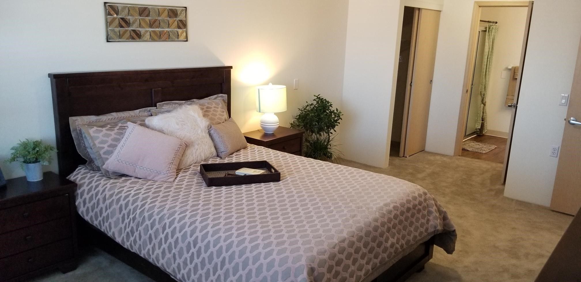 Interior design of a cozy bedroom at Solstice Senior Living At Apple Valley with elegant decor.