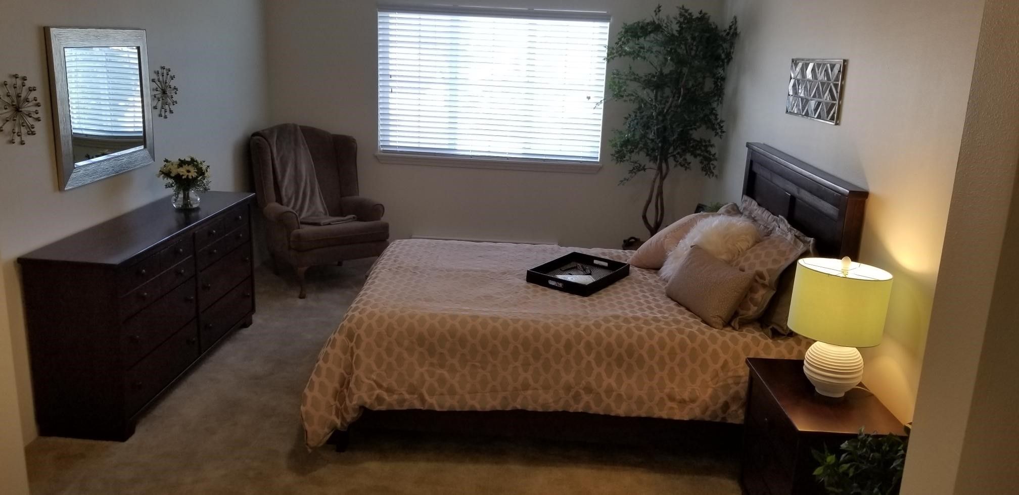 Interior of a bedroom at Solstice Senior Living At Apple Valley featuring modern decor and electronics.