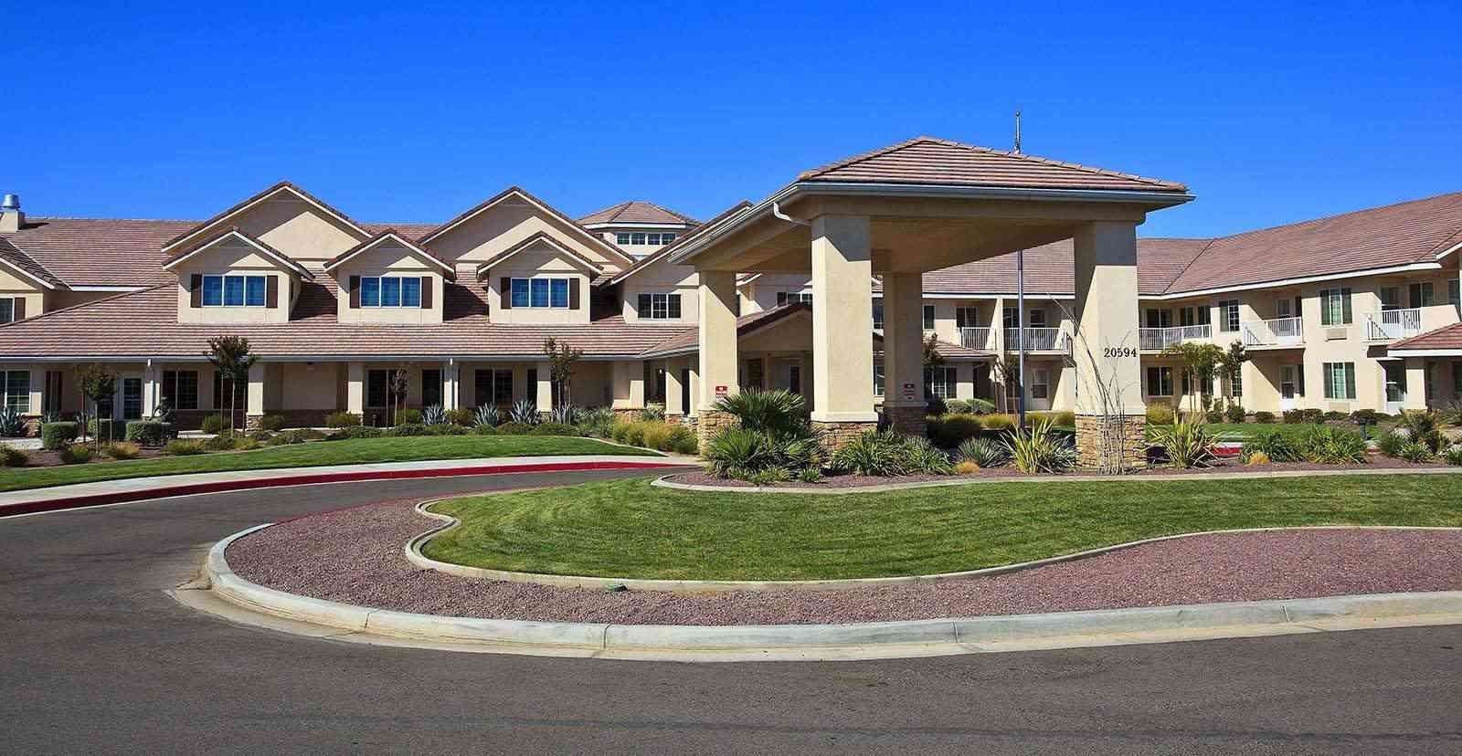Neighborhood view of Solstice Senior Living At Apple Valley with lush grass and modern architecture.