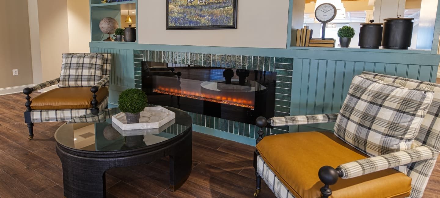 Interior view of Cadence At Olney senior living community featuring modern decor and cozy fireplace.