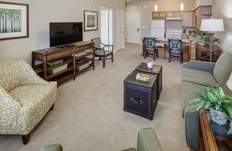Senior living room at Merrill Gardens, Huntington Beach with modern furniture, electronics, and art.