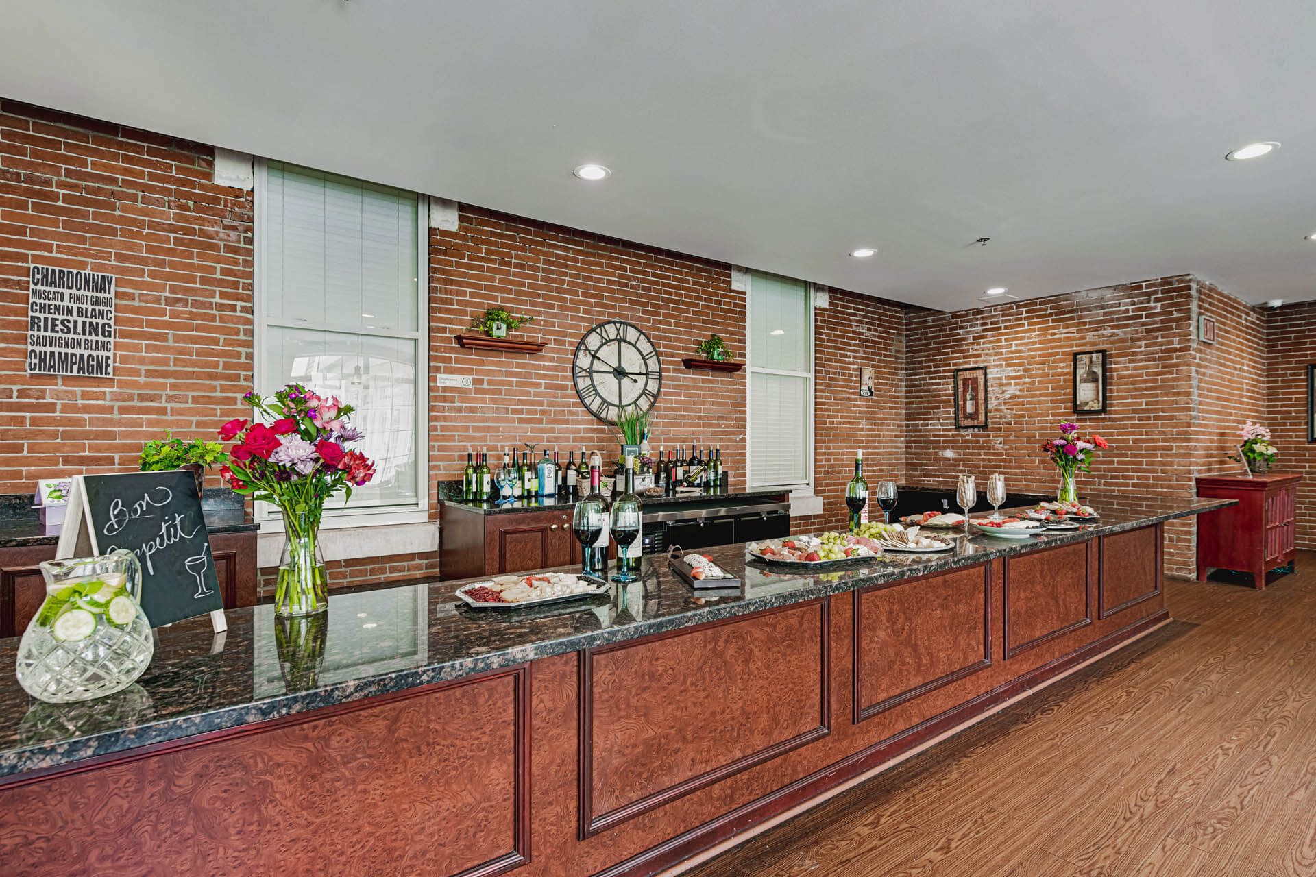 Interior view of Woodbury Mews senior living community with a well-designed kitchen, cafeteria, and floral decor.