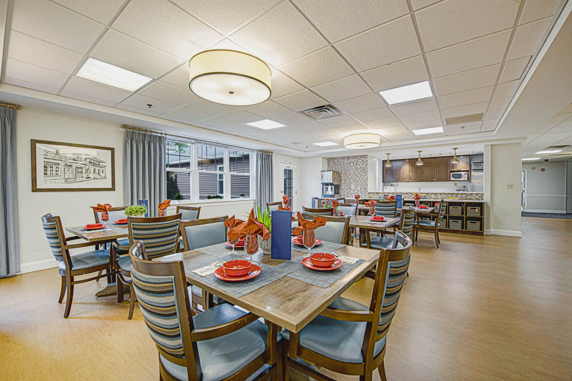 Interior view of Woodbury Mews senior living community featuring dining room and furniture.