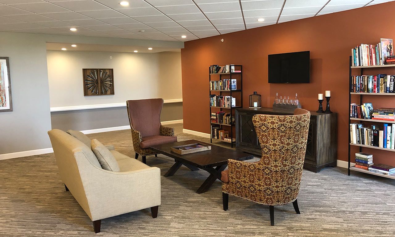 Senior living community interior at Overlook Village featuring furniture, decor, and electronics.