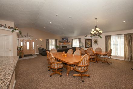 Interior view of Caring Hearts Assisted Living featuring elegant dining room with modern decor.
