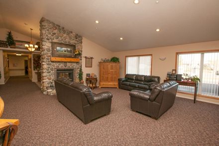 Senior living room interior at Caring Hearts Assisted Living with modern decor and electronics.