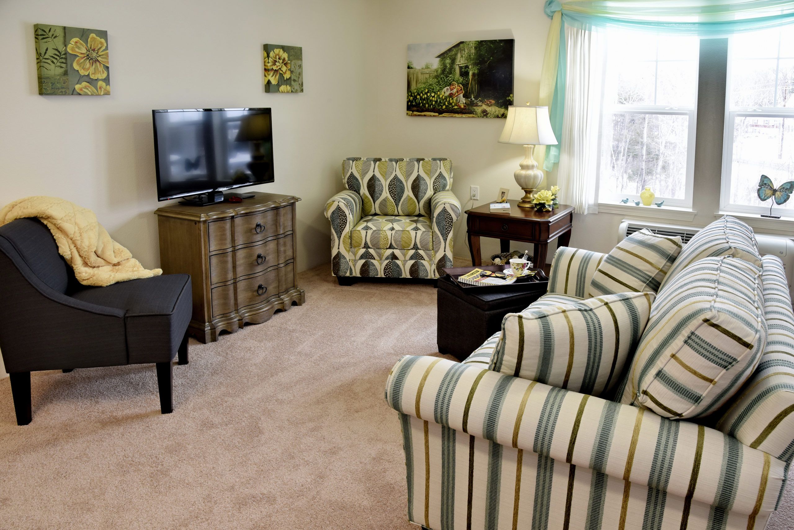 Senior enjoying modern amenities in the living room at Magnolia Heights Retirement Community.