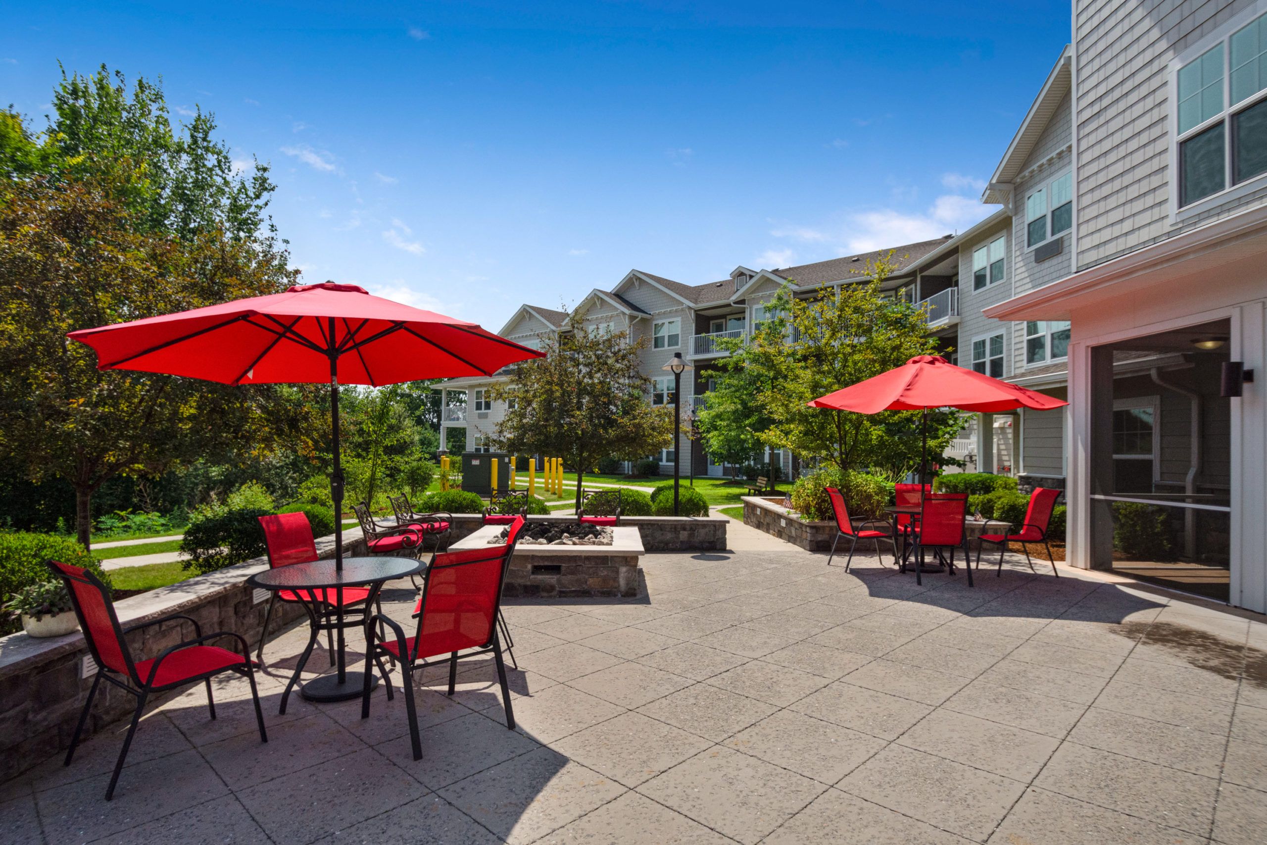 Senior living community, Magnolia Heights, featuring urban architecture, outdoor patio, and scenic walkway.