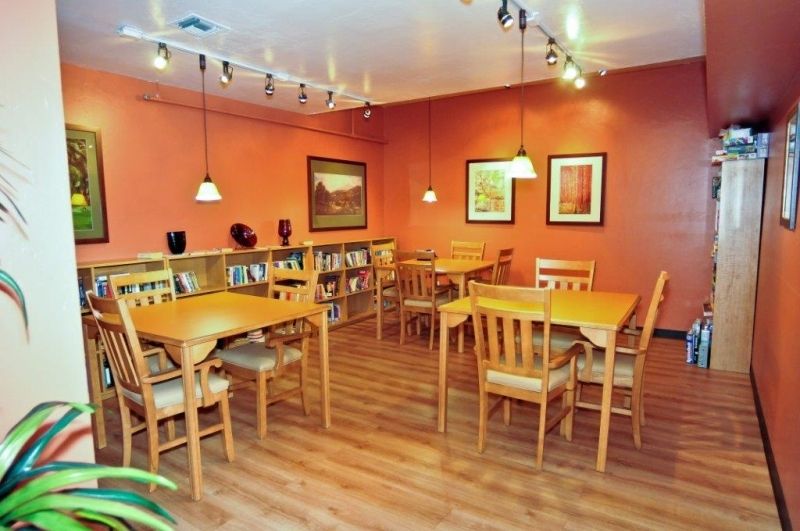 Interior view of Boulder Gardens Assisted Living featuring hardwood dining area with art decor.