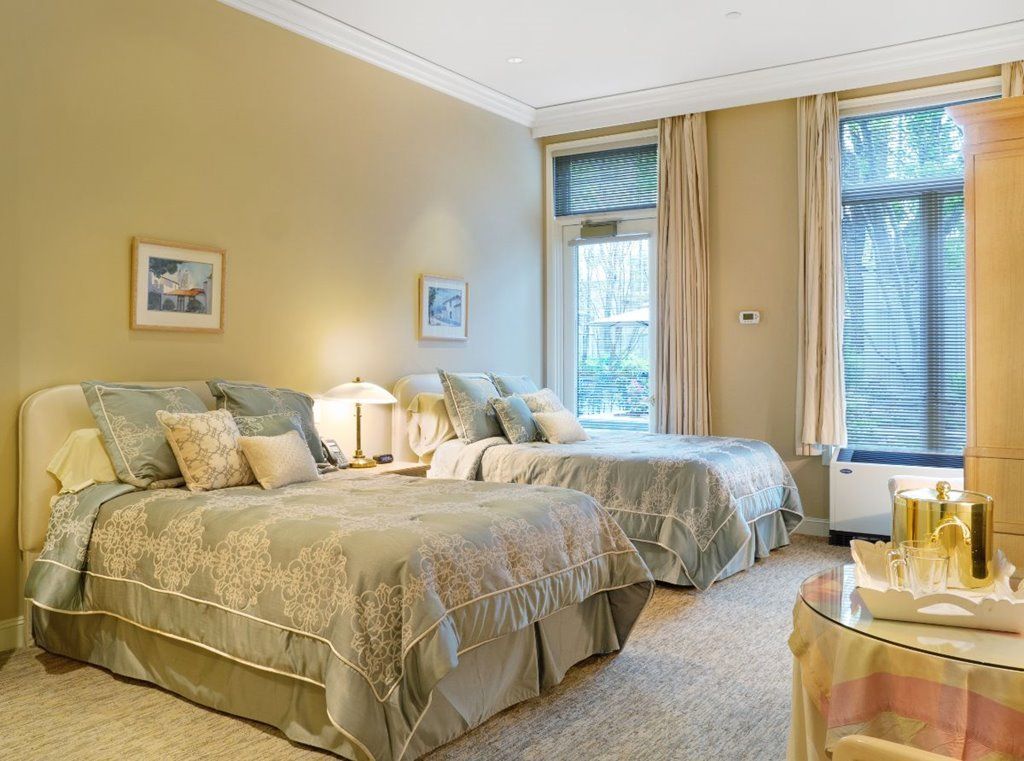 Interior design of a cozy bedroom with furniture and decor at The Stratford senior living community.
