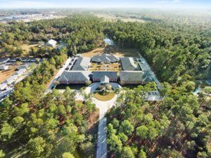 Aerial view of SummerHouse Park Provence senior living community, featuring lush woodland and park.