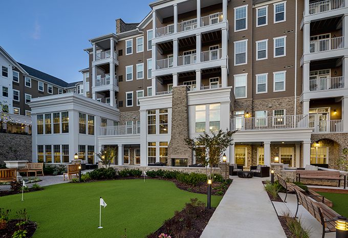 Senior living community, Brightview Columbia, featuring high-rise apartments, lush lawns, and urban architecture.