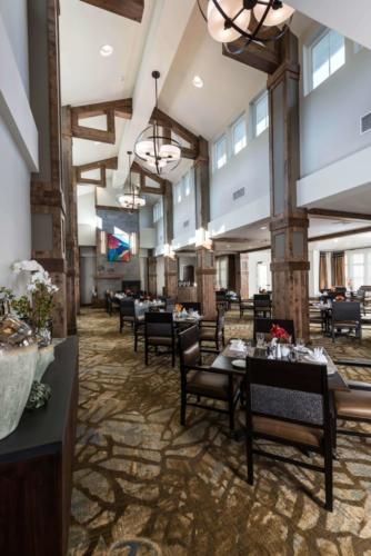 Interior view of Heartis Peoria senior living community featuring reception, dining area, and decor.