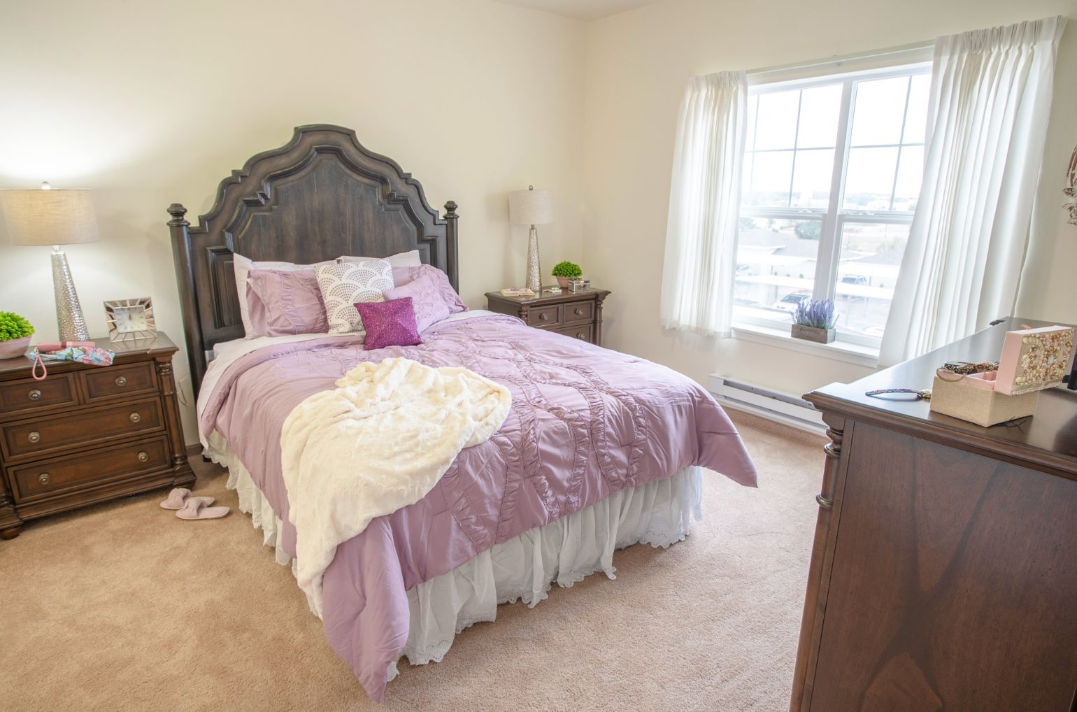 Interior view of a well-furnished bedroom at Maple Ridge Gracious Retirement Living community.