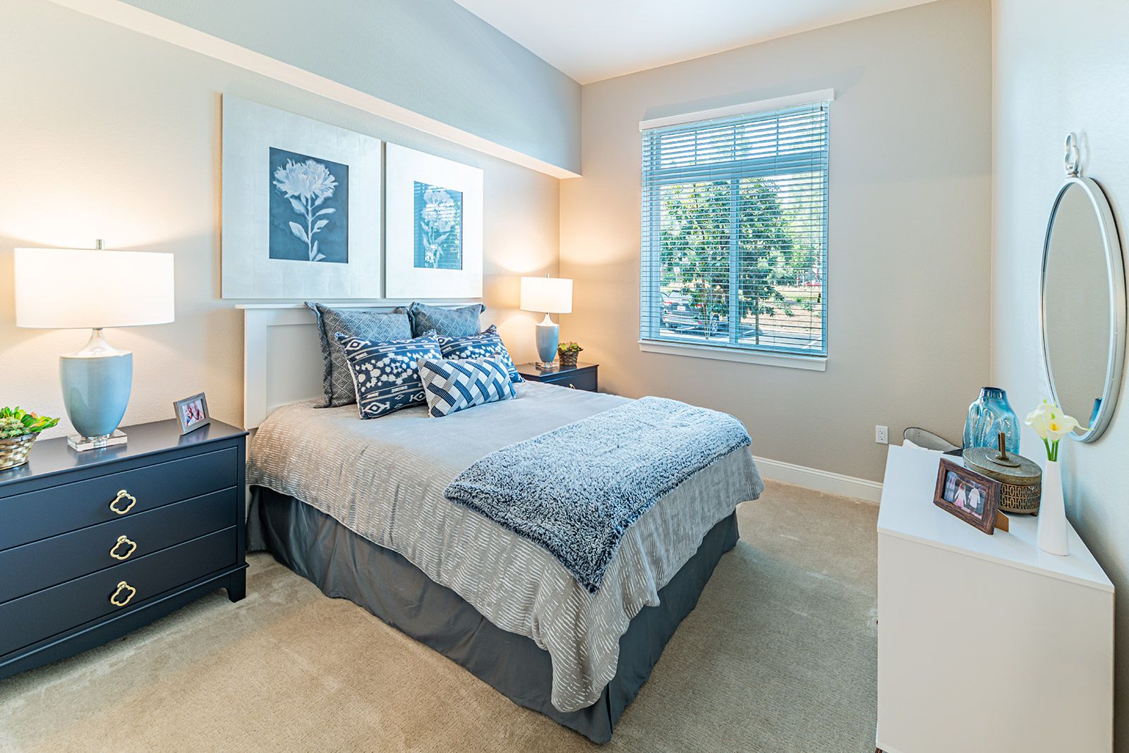 Interior view of a cozy bedroom at Allara Senior Living with tasteful decor, furniture, and plants.